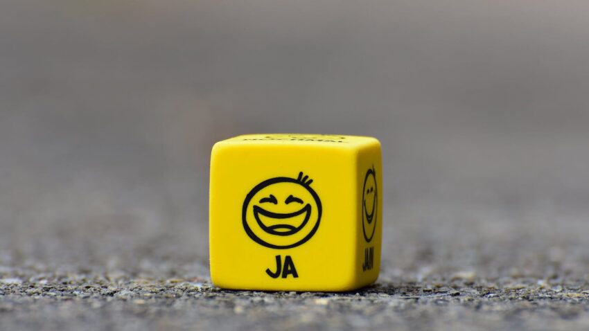 yellow cube on brown pavement
