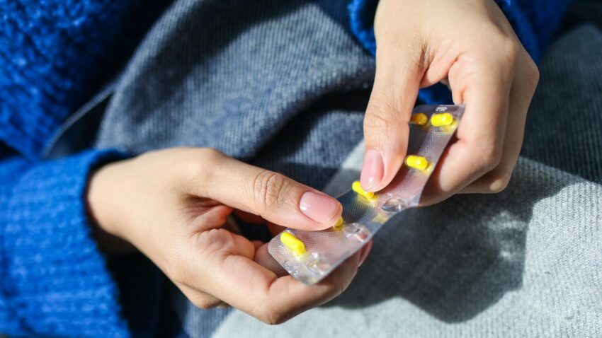 person holding blister pack